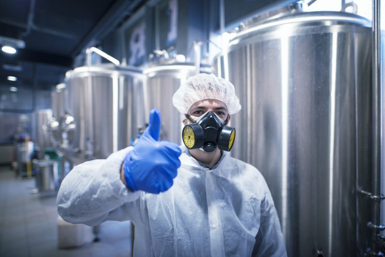 technologist-specialist-in-white-protection-suit-wearing-gas-mask-for-safety-at-work